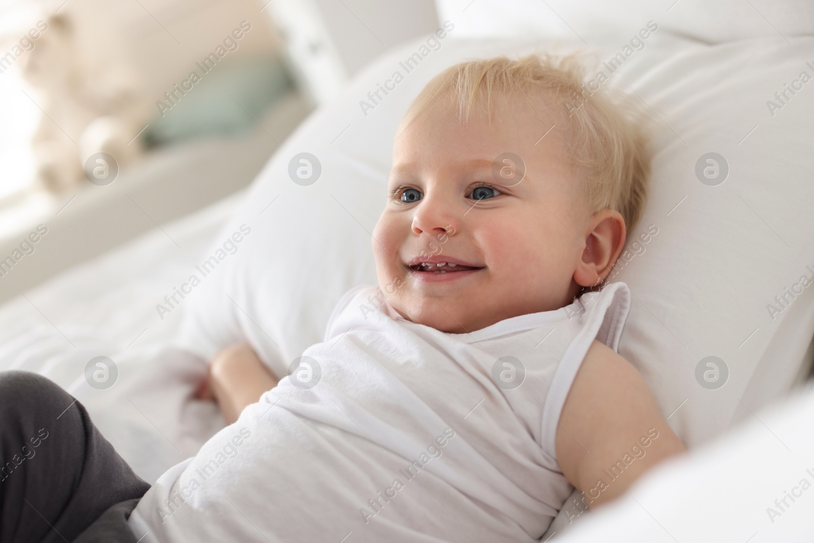 Bedtime. Cute little baby on bed at home Photo of Bedtime. Cute little baby on bed at home