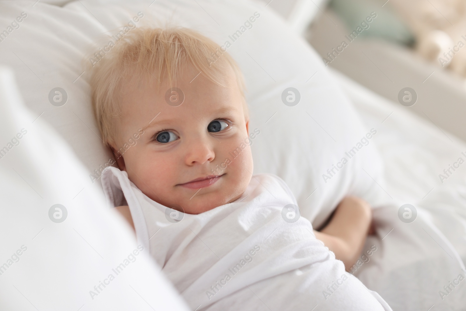 Bedtime. Cute little baby on bed at home Photo of Bedtime. Cute little baby on bed at home