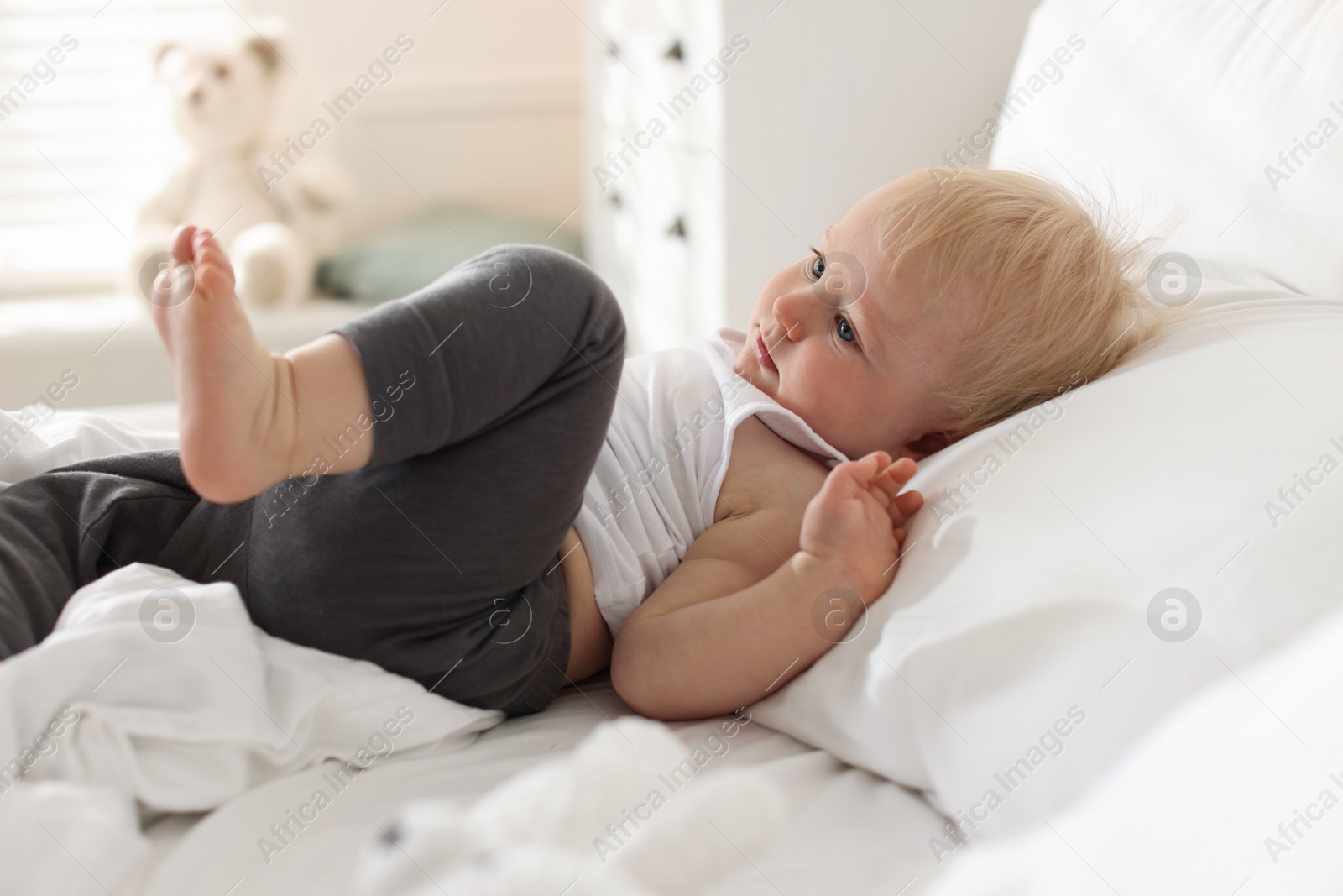 Bedtime. Cute little baby on bed at home Photo of Bedtime. Cute little baby on bed at home