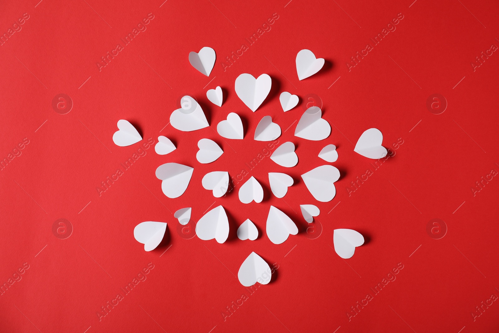 Many paper hearts on red background, flat lay Photo of Many paper hearts on red background, flat lay