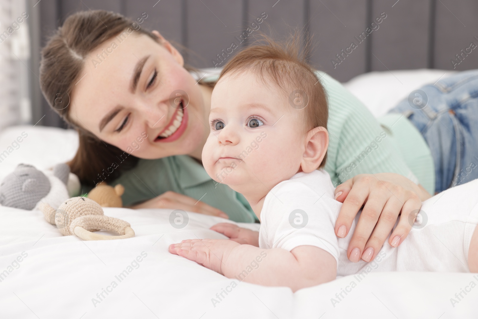 Mother with her cute little baby on bed at home, selective focus Photo of Mother with her cute little baby on bed at home, selective focus