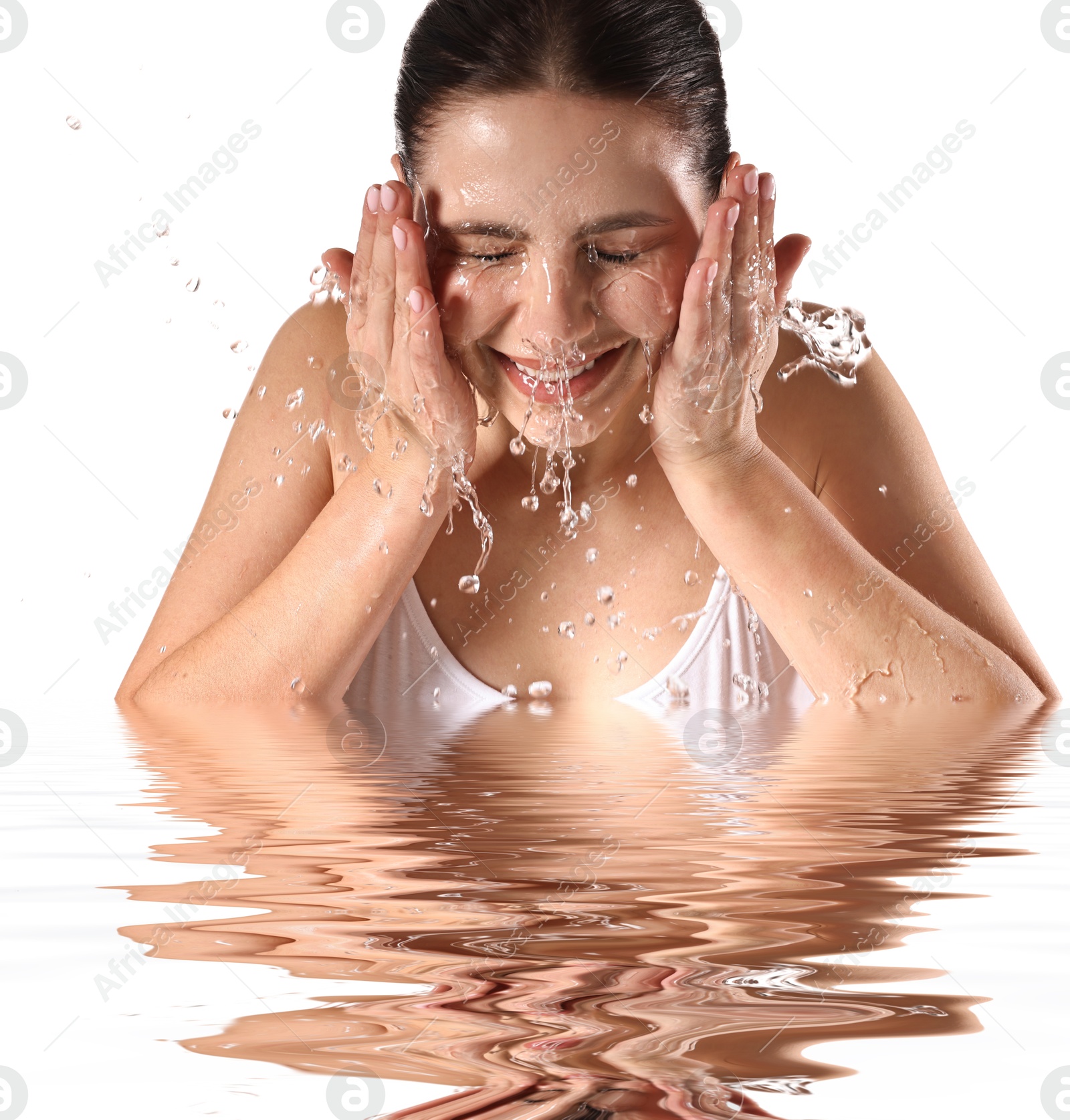 Beautiful woman washing her face in water on white background Image of Beautiful woman washing her face in water on white background