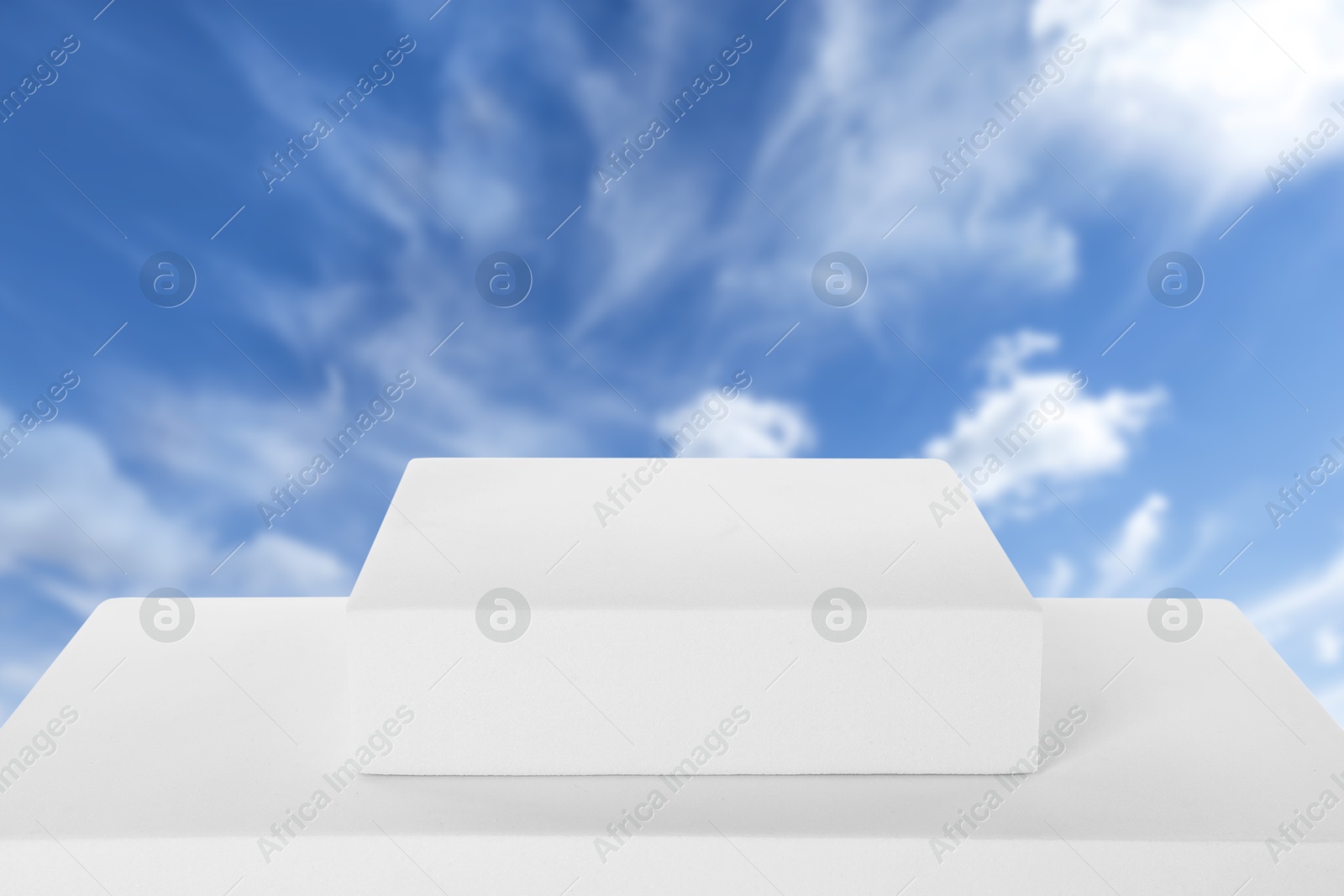 White podium against blue sky with clouds . Image of White podium against blue sky with clouds .