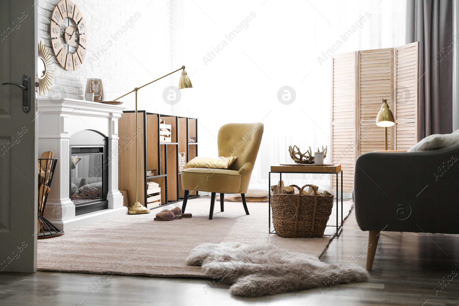 Firewood and modern furniture in light living room Photo of Firewood and modern furniture in light living room