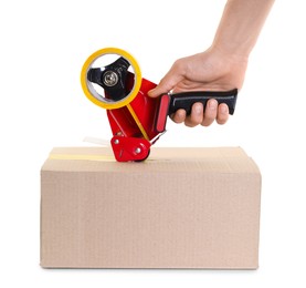 Photo of Man using dispenser with adhesive tape to seal cardboard box on white background, closeup