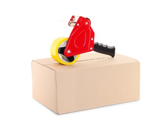 Photo of Dispenser with adhesive tape on cardboard box against white background
