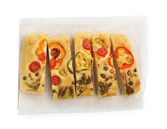 Photo of Cut delicious focaccia with flowers made of vegetables isolated on white, top view