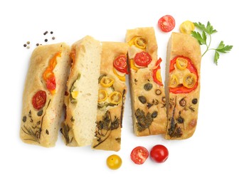Photo of Cut delicious focaccia with flowers made of vegetables and ingredients isolated on white, top view