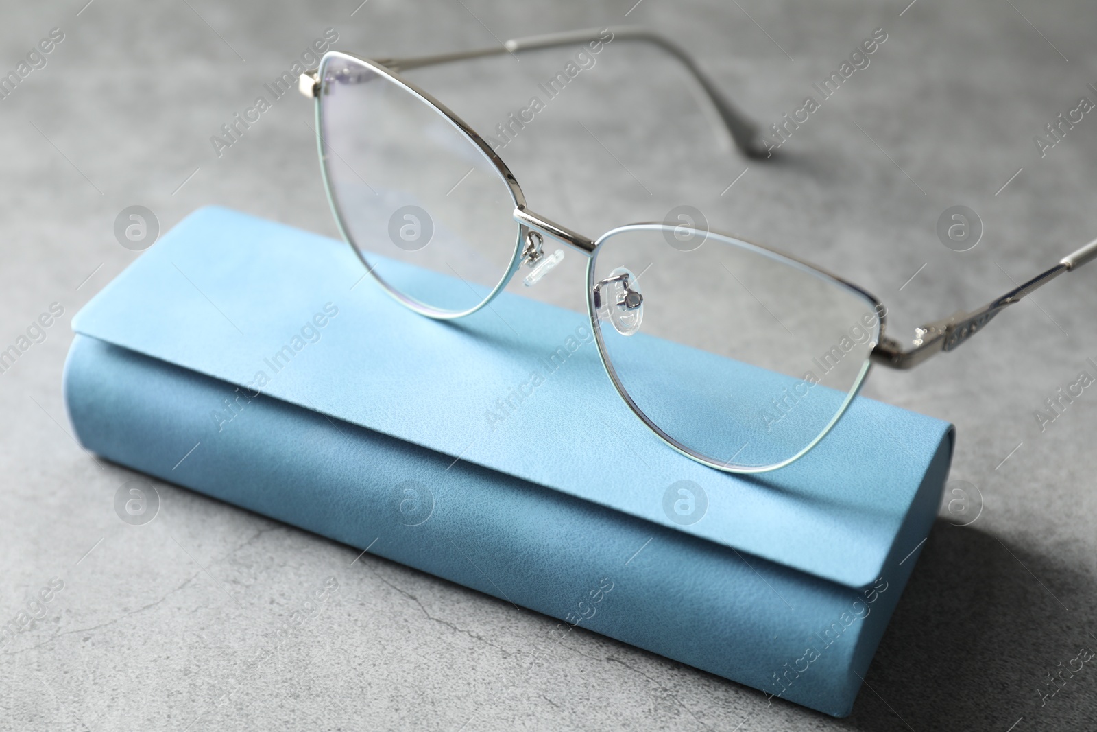 Case with stylish glasses on grey table, closeup Photo of Case with stylish glasses on grey table, closeup