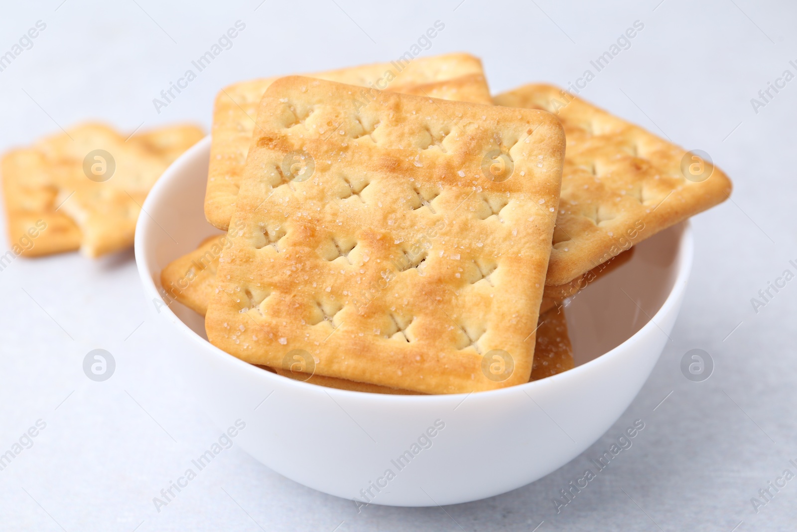 Tasty salty crackers on white table, closeup Photo of Tasty salty crackers on white table, closeup