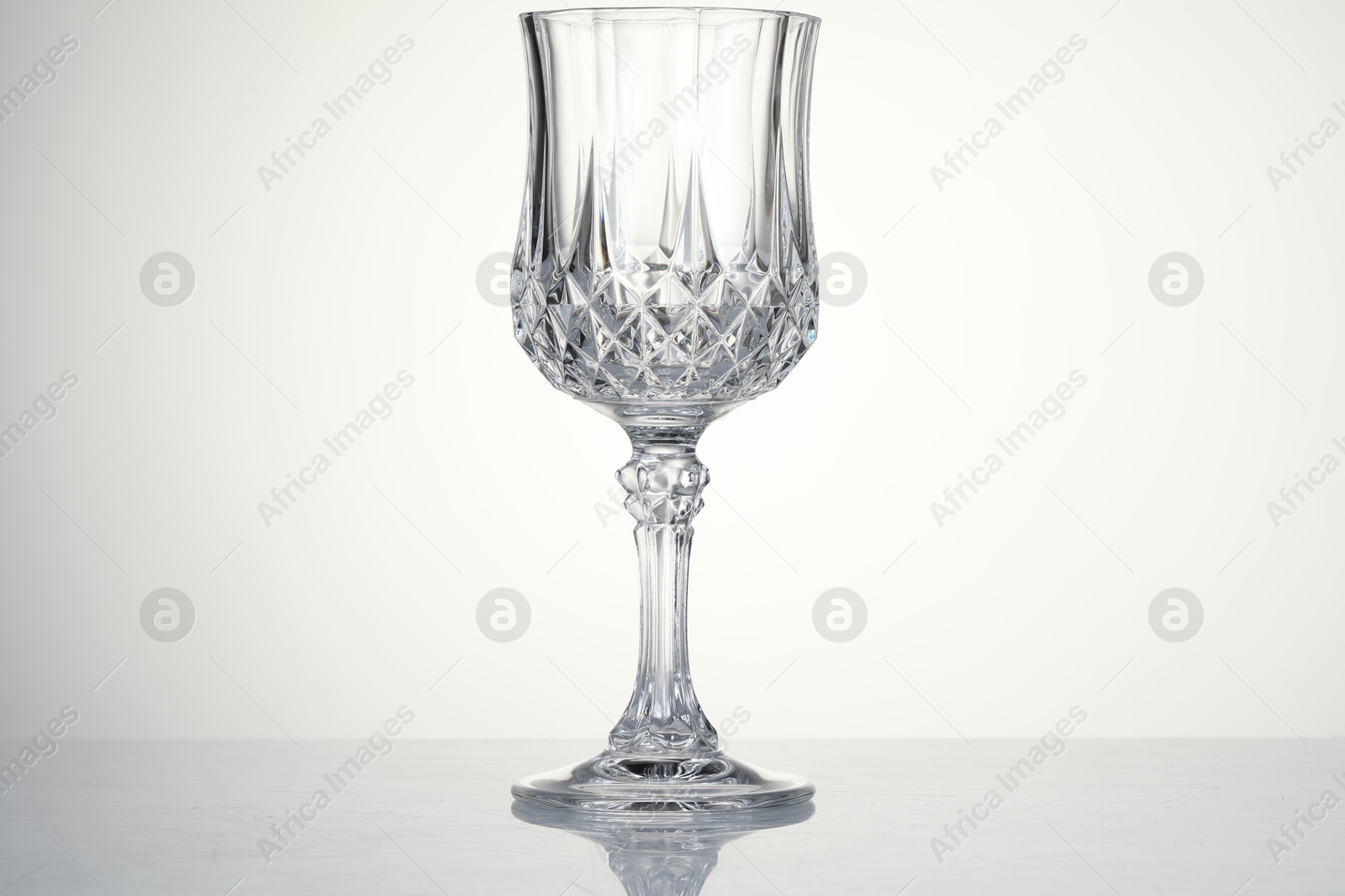 Photo of One empty clean glass isolated on white