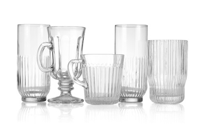 Photo of Different empty clean glasses isolated on white