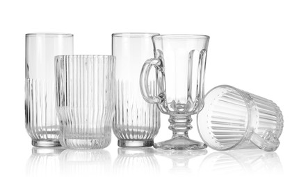 Photo of Different empty clean glasses isolated on white