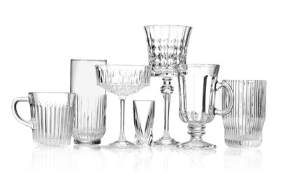 Photo of Different empty clean glasses isolated on white
