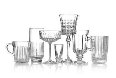 Photo of Different empty clean glasses isolated on white