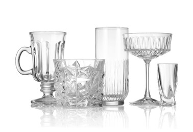 Photo of Different empty clean glasses isolated on white