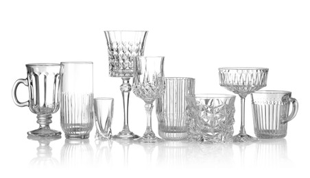 Photo of Different empty clean glasses isolated on white