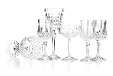 Photo of Different empty clean glasses isolated on white