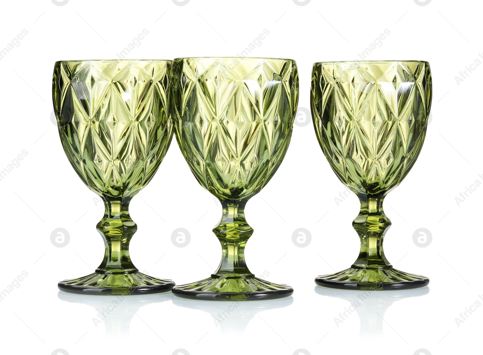 Photo of Three empty clean glasses isolated on white