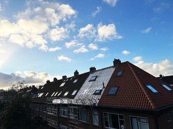 Photo of Residential building with roof renovation under blue sky