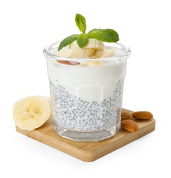 Photo of Delicious dessert with chia seeds, yogurt, banana, almond and mint in glass on white background. Superfood