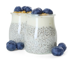 Photo of Delicious pudding with chia seeds, yogurt, blueberries and granola in glasses isolated on white. Superfood