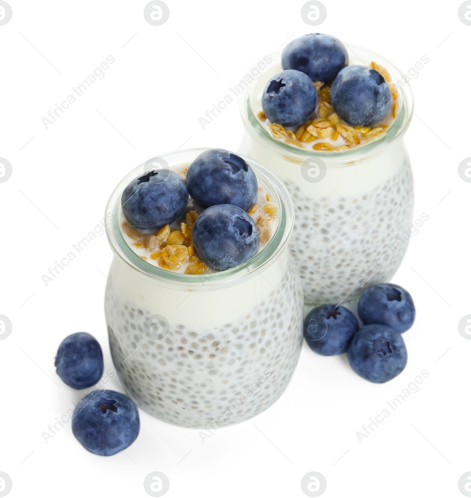 Delicious pudding with chia seeds, yogurt, blueberries and granola in glasses isolated on white. Superfood Photo of Delicious pudding with chia seeds, yogurt, blueberries and granola in glasses isolated on white. Superfood