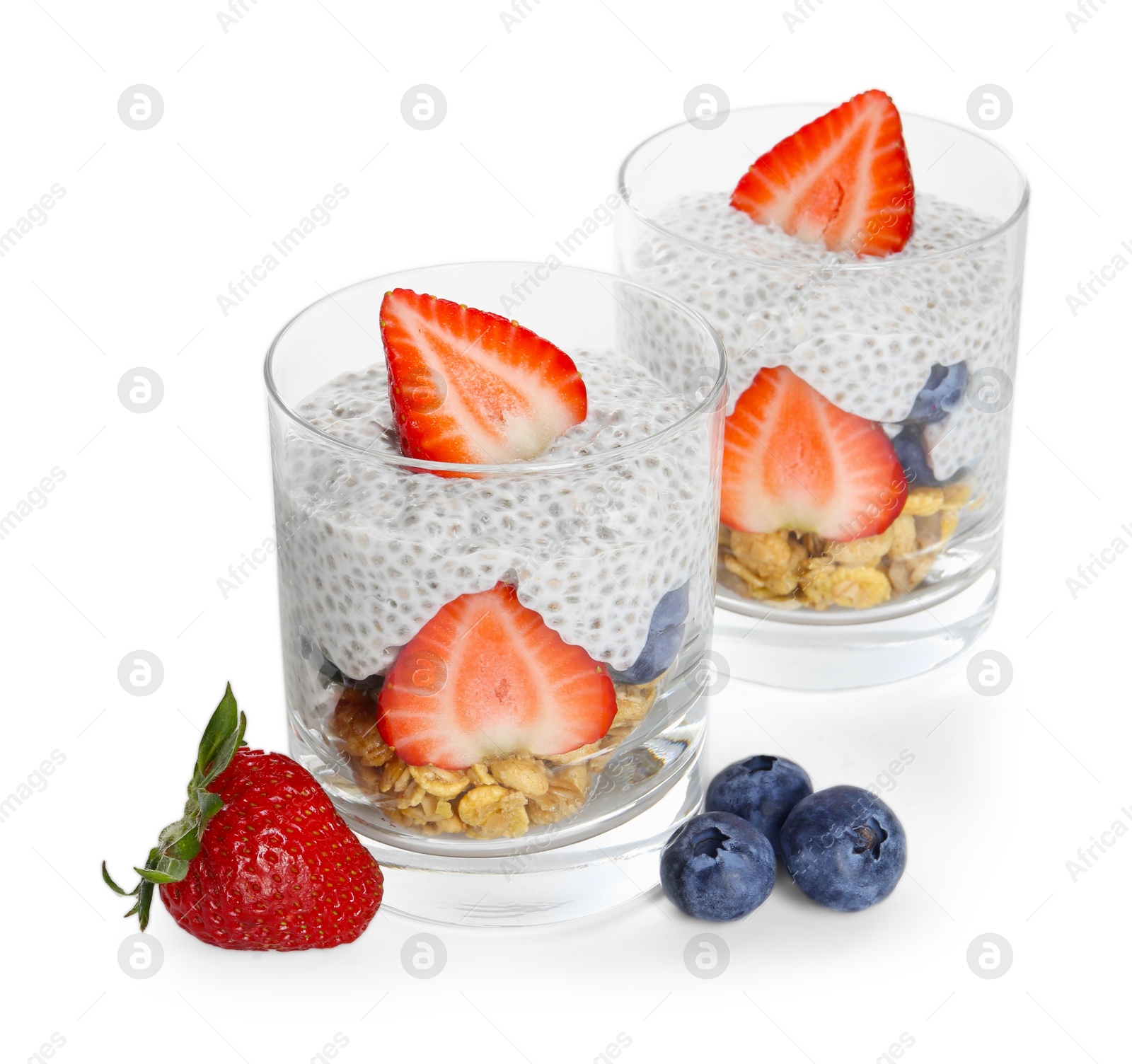 Delicious dessert with chia seeds, yogurt, granola, strawberries and blueberries in glasses isolated on white. Superfood Photo of Delicious dessert with chia seeds, yogurt, granola, strawberries and blueberries in glasses isolated on white. Superfood