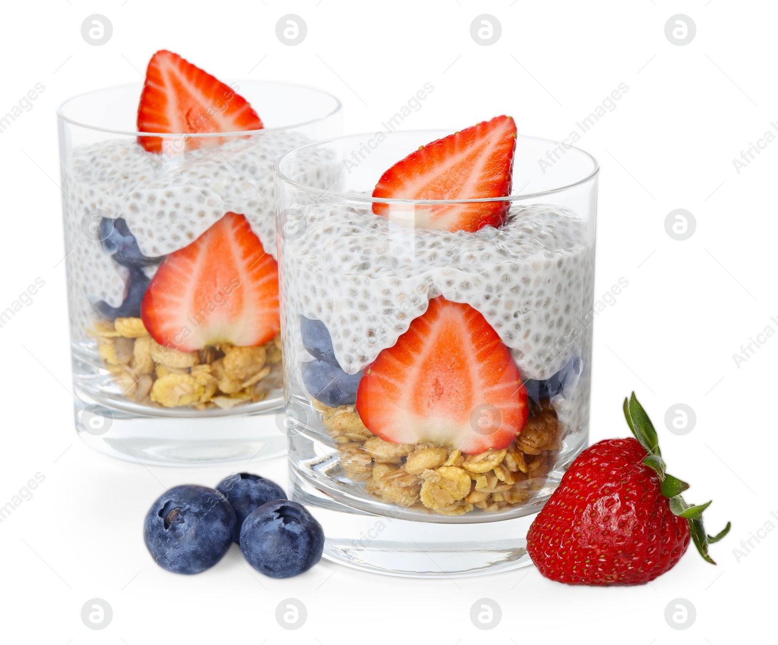 Delicious dessert with chia seeds, yogurt, granola, strawberries and blueberries in glasses isolated on white. Superfood Photo of Delicious dessert with chia seeds, yogurt, granola, strawberries and blueberries in glasses isolated on white. Superfood