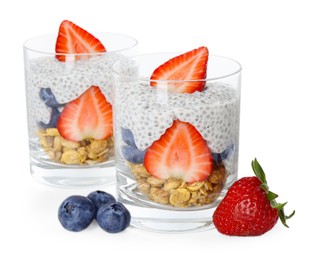 Photo of Delicious dessert with chia seeds, yogurt, granola, strawberries and blueberries in glasses isolated on white. Superfood