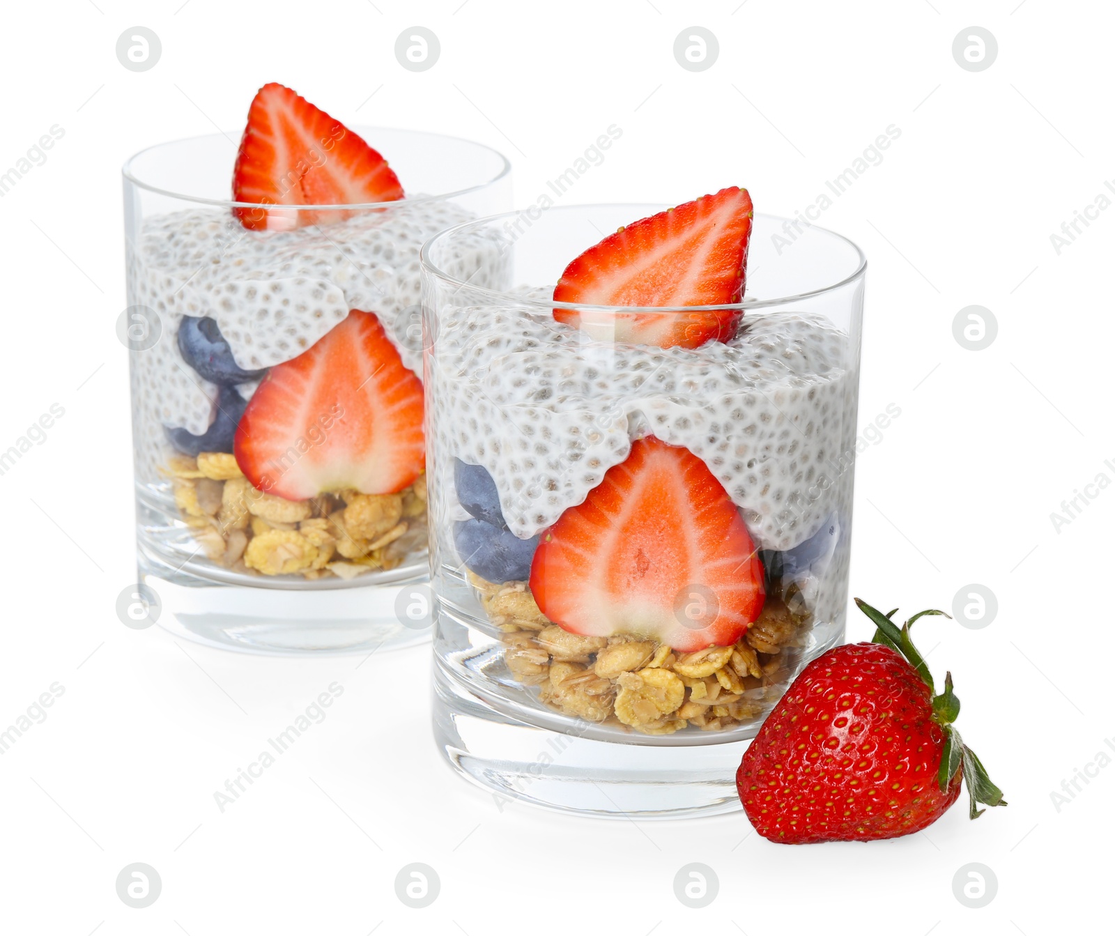 Delicious dessert with chia seeds, yogurt, granola, strawberries and blueberries in glasses isolated on white. Superfood Photo of Delicious dessert with chia seeds, yogurt, granola, strawberries and blueberries in glasses isolated on white. Superfood