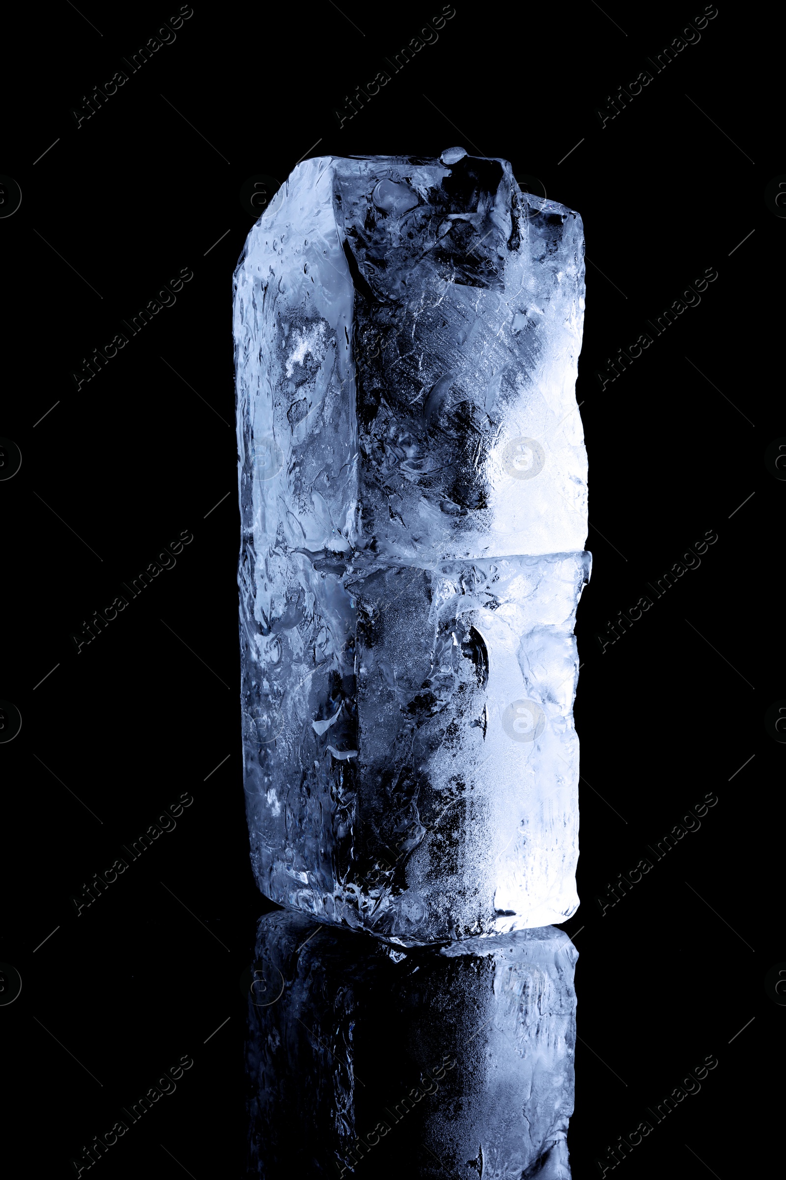 Blocks of clear ice on black mirror surface Image of Blocks of clear ice on black mirror surface