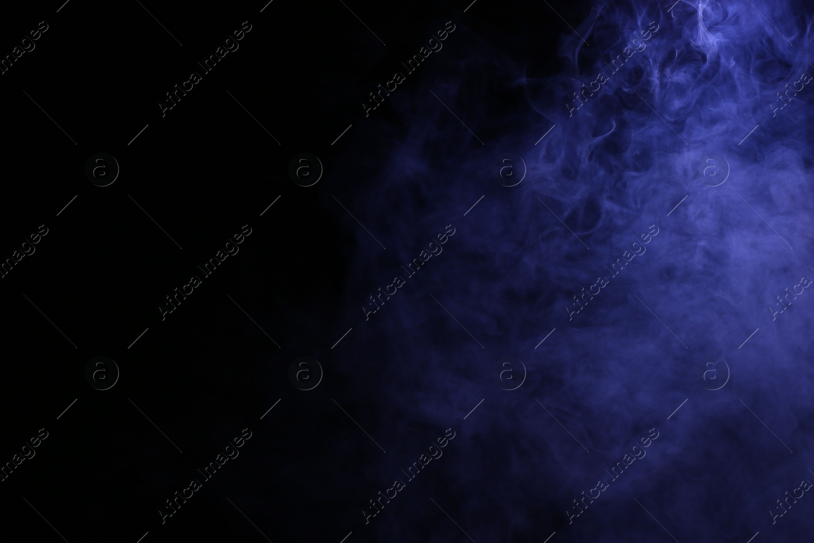 Beautiful smoke in blue light on dark background. Space for text Photo of Beautiful smoke in blue light on dark background. Space for text