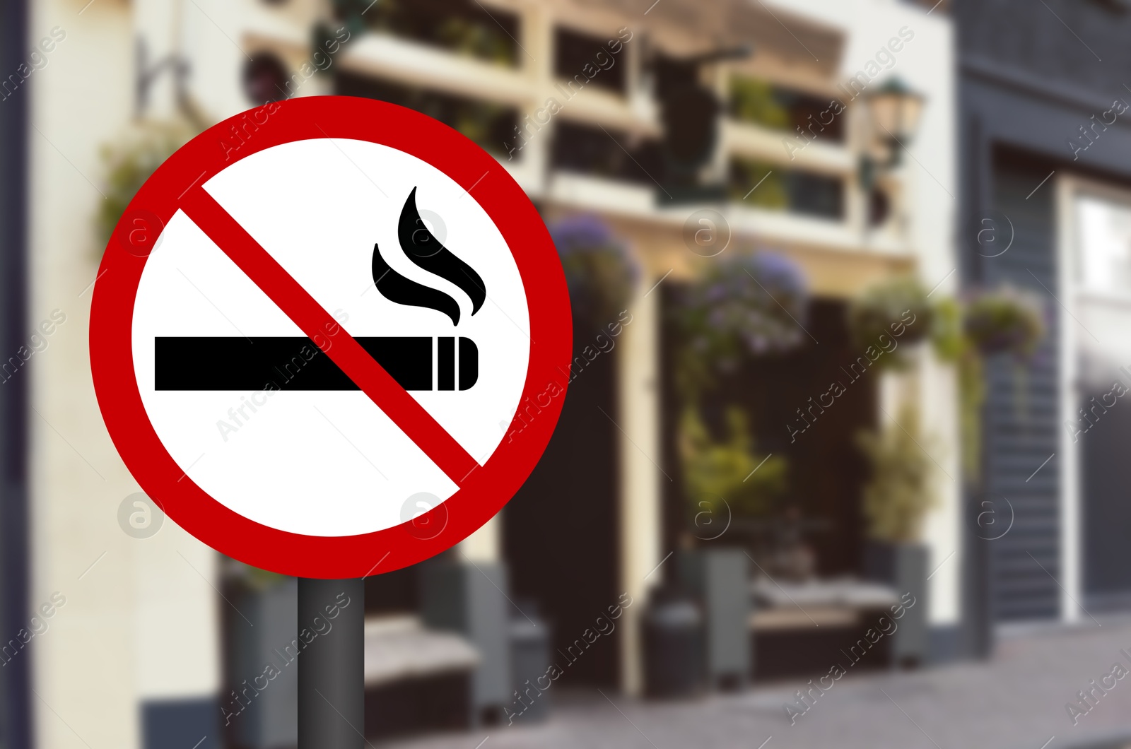 No Smoking sign on city street. Space for text Image of No Smoking sign on city street. Space for text