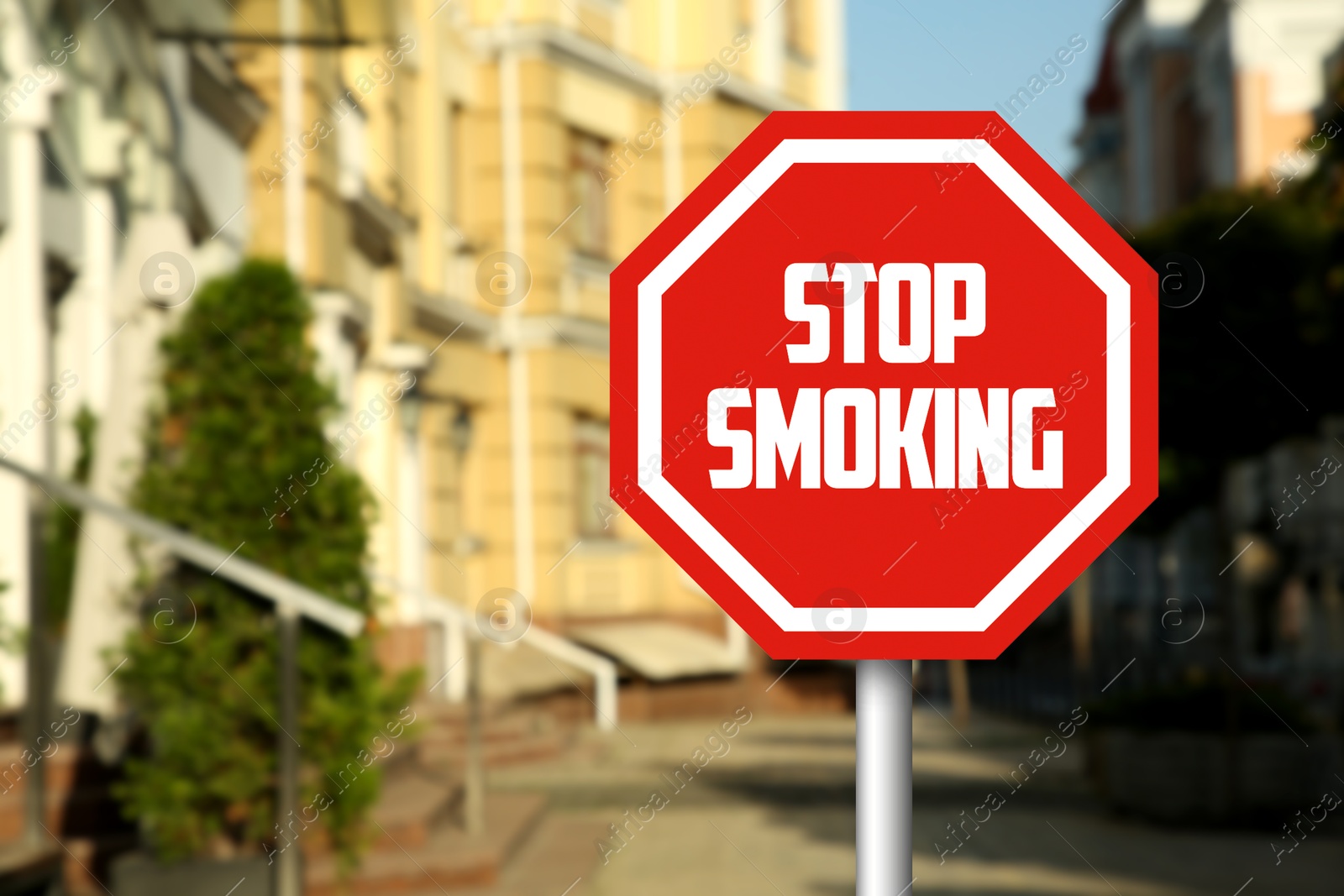 Stop Smoking sign on city street. Space for text Image of Stop Smoking sign on city street. Space for text