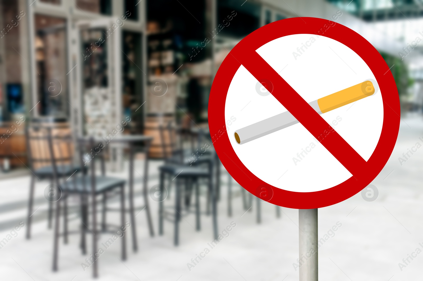 No Smoking sign near outdoor cafe on city street. Space for text Image of No Smoking sign near outdoor cafe on city street. Space for text