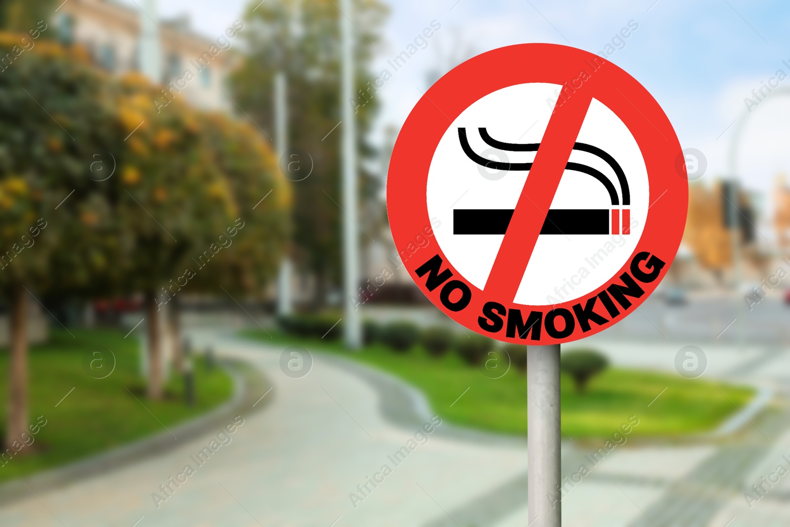 No Smoking sign on city street. Space for text Image of No Smoking sign on city street. Space for text