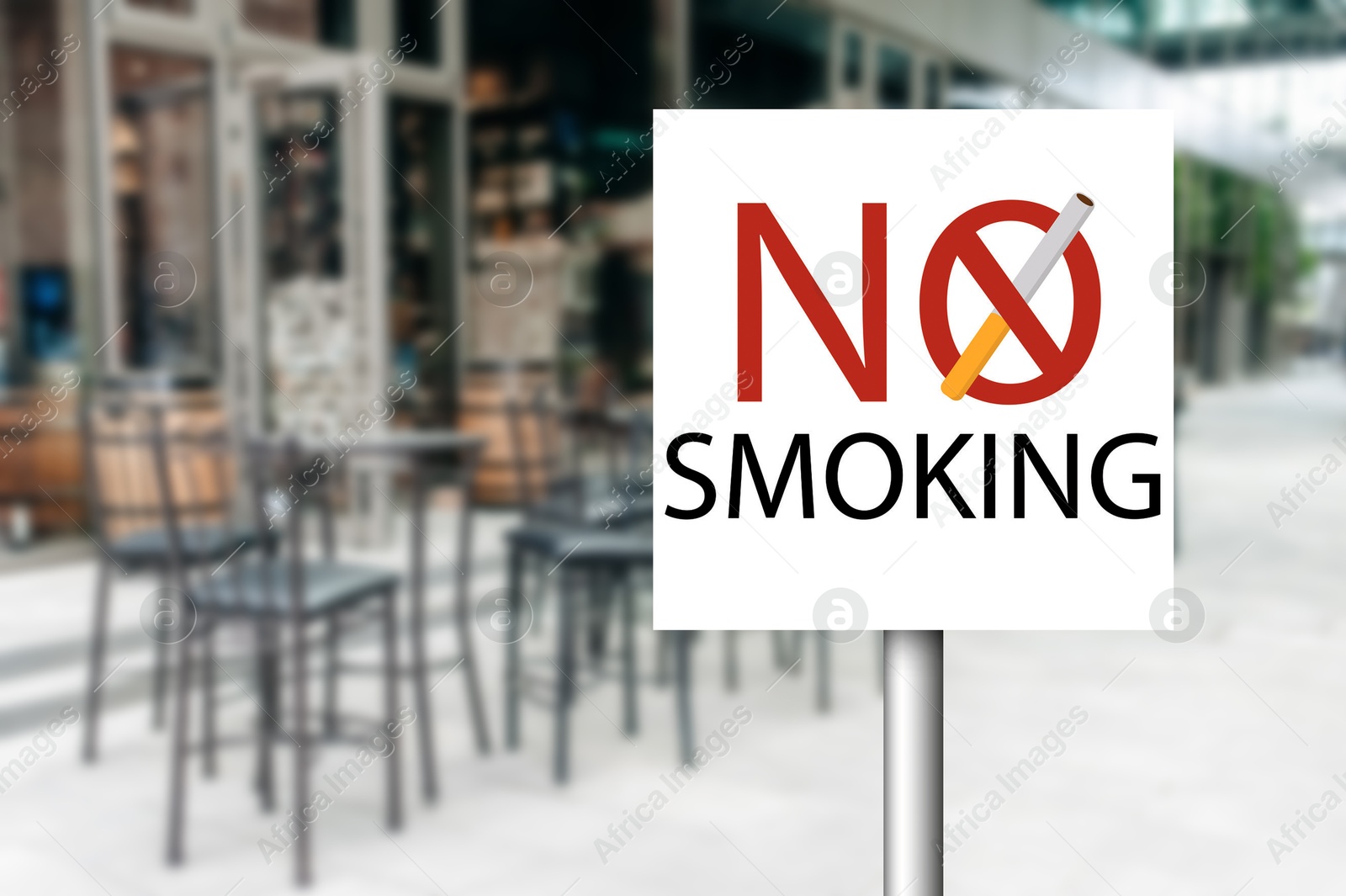 No Smoking sign near outdoor cafe on city street. Space for text Image of No Smoking sign near outdoor cafe on city street. Space for text
