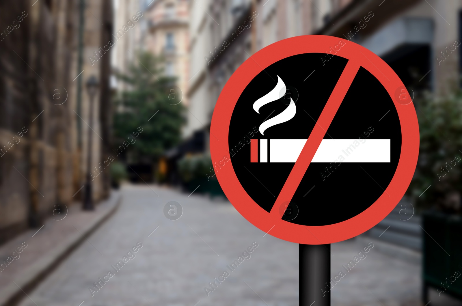 No Smoking sign on city street. Space for text Image of No Smoking sign on city street. Space for text