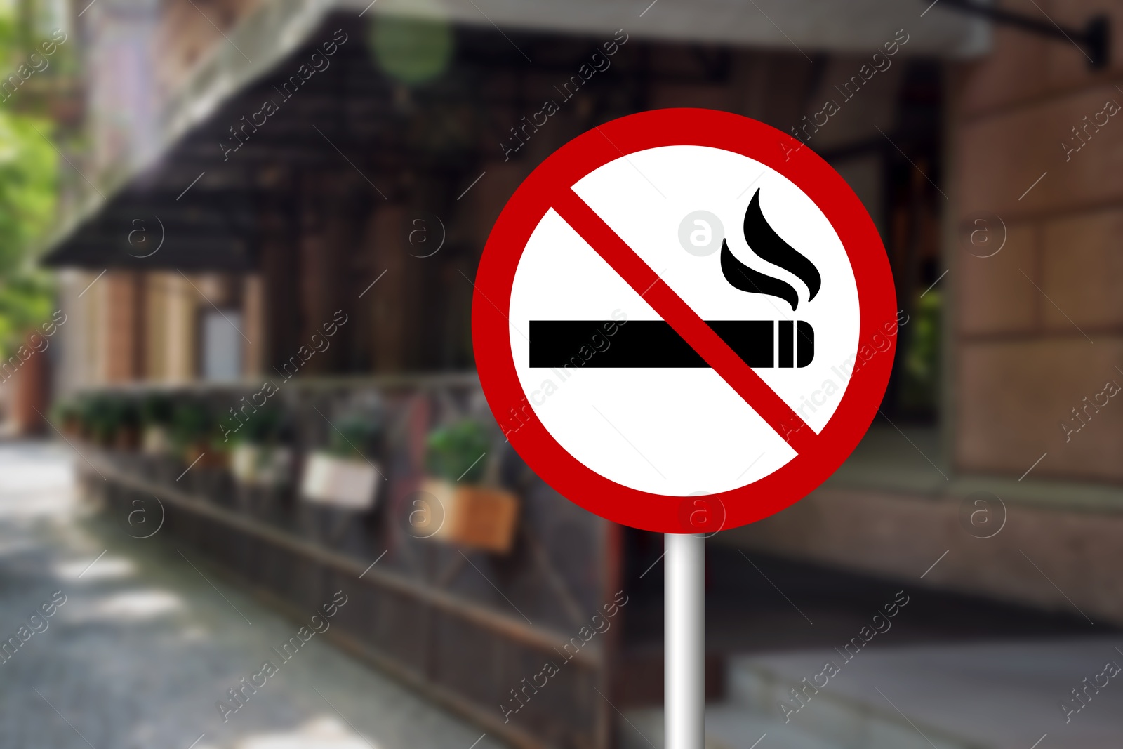 No Smoking sign on city street. Space for text Image of No Smoking sign on city street. Space for text