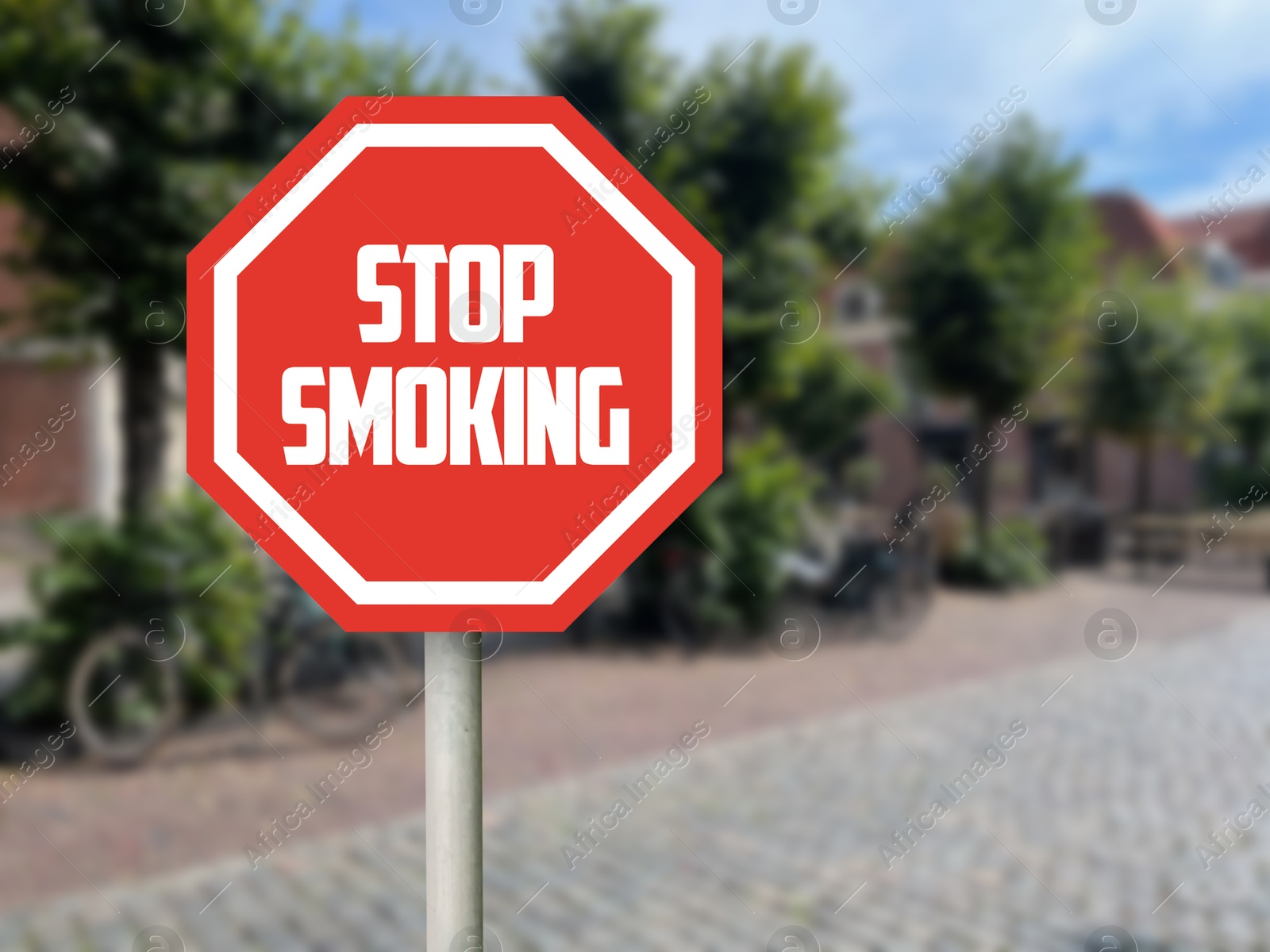 Stop Smoking sign on city street. Space for text Image of Stop Smoking sign on city street. Space for text