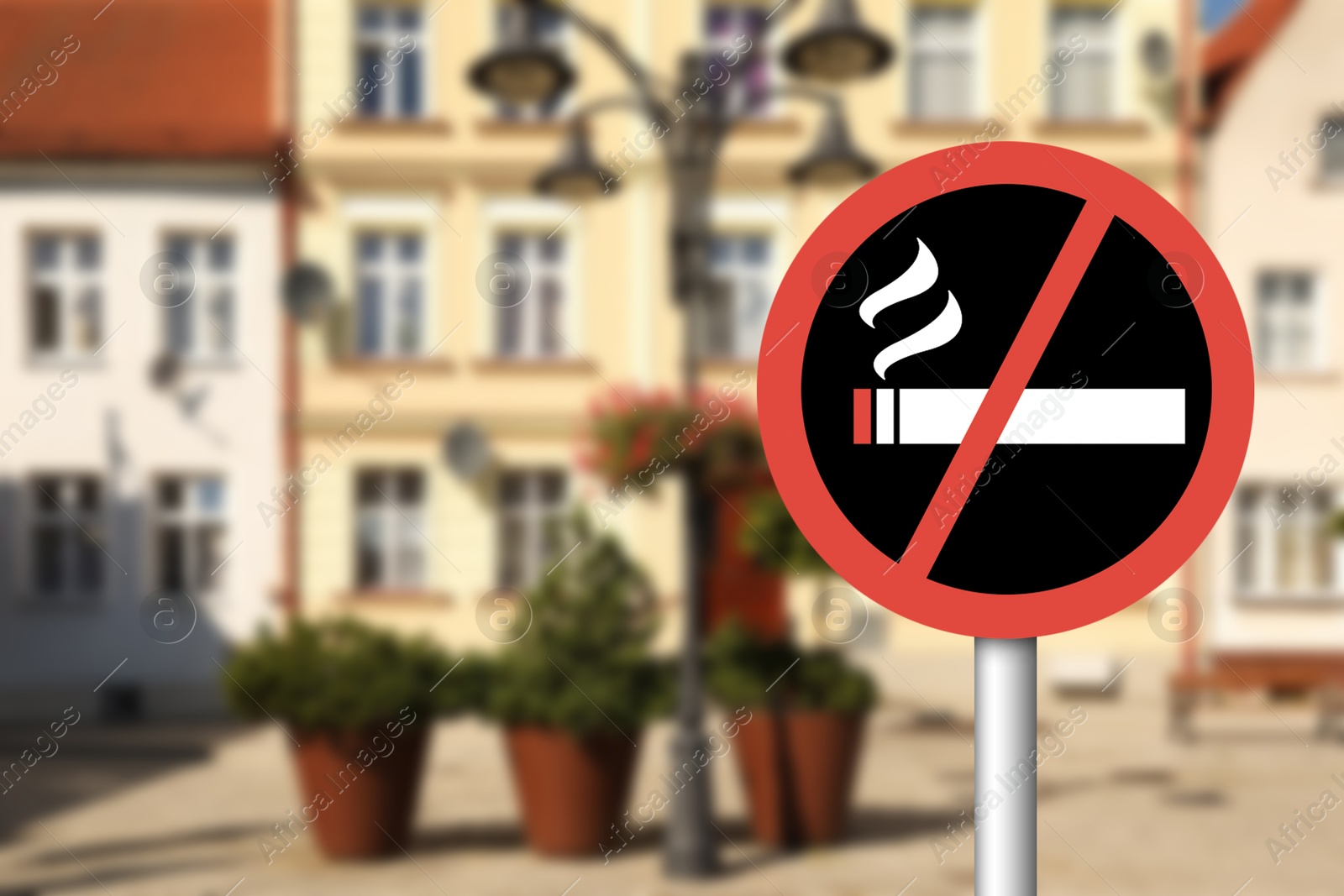 Image of No Smoking sign on city street. Space for text
