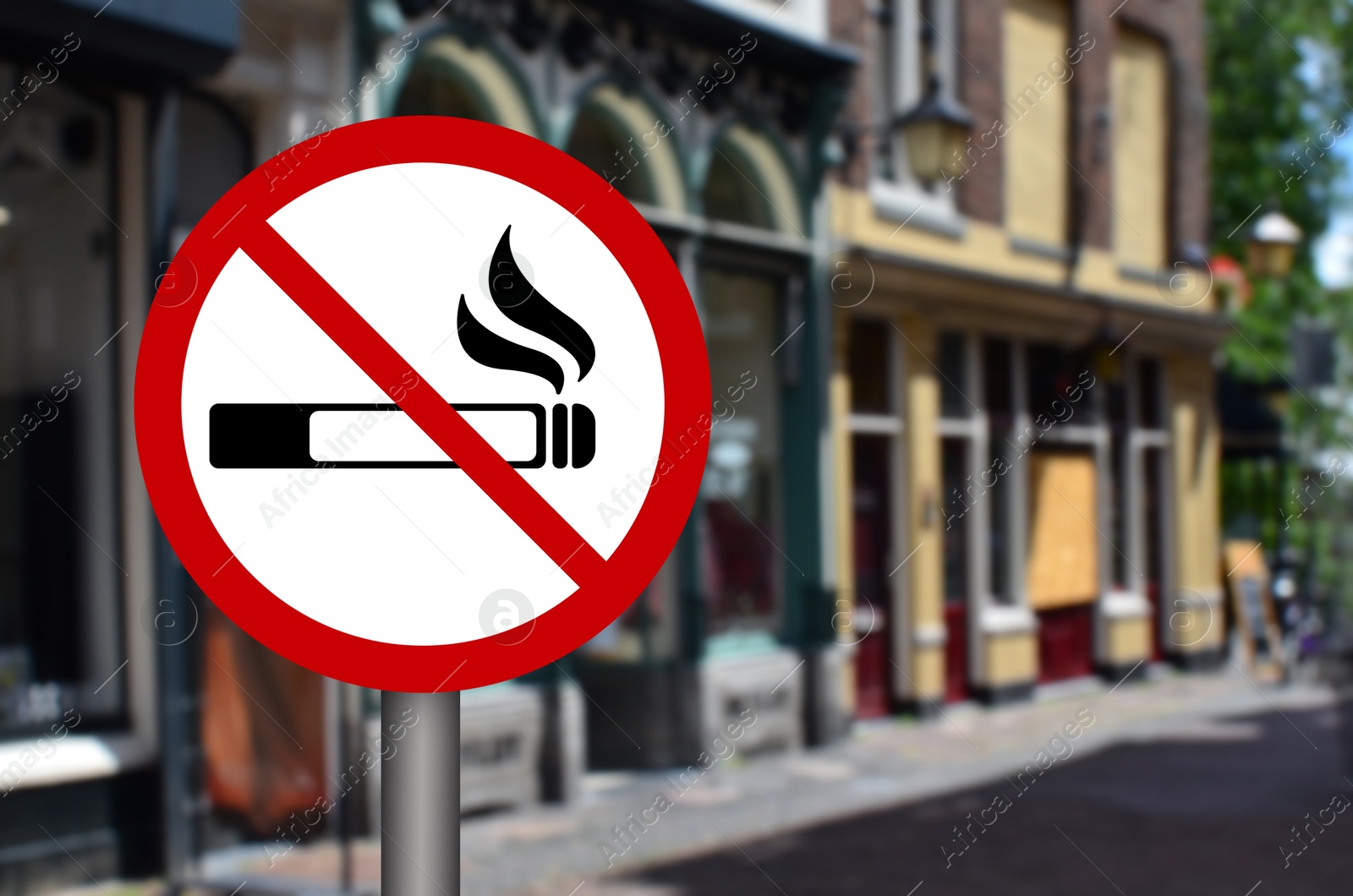 No Smoking sign on city street. Space for text Image of No Smoking sign on city street. Space for text