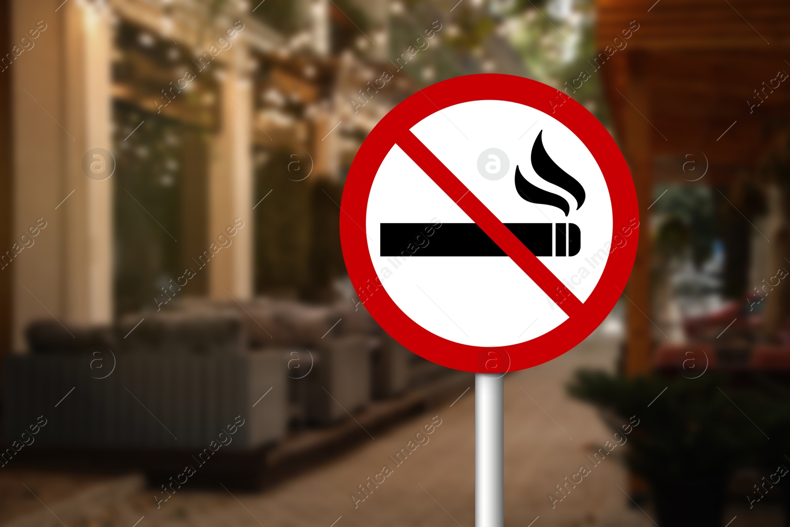 No Smoking sign near cafe on city street. Space for text Image of No Smoking sign near cafe on city street. Space for text