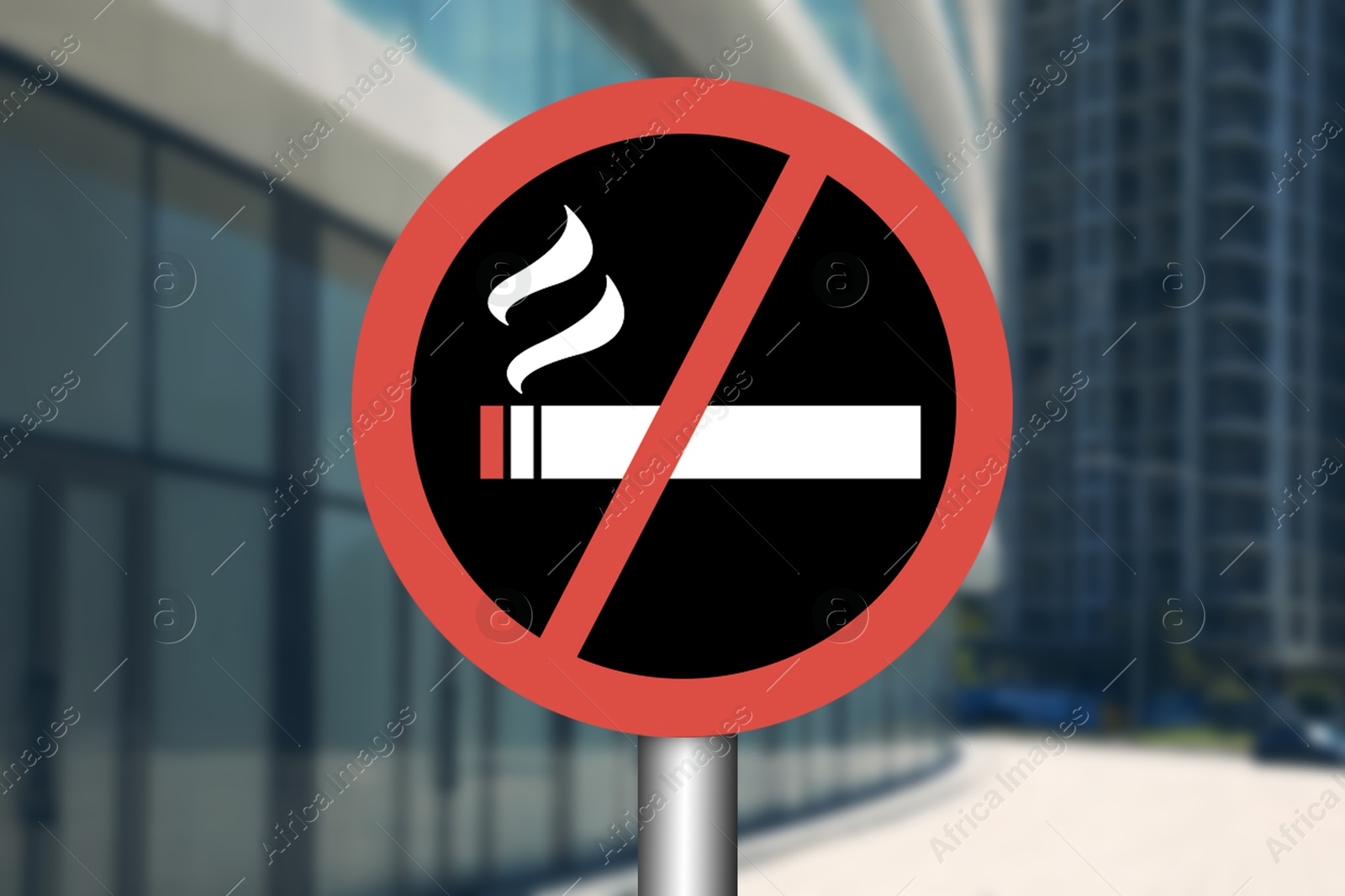 No Smoking sign near buildings in city Image of No Smoking sign near buildings in city