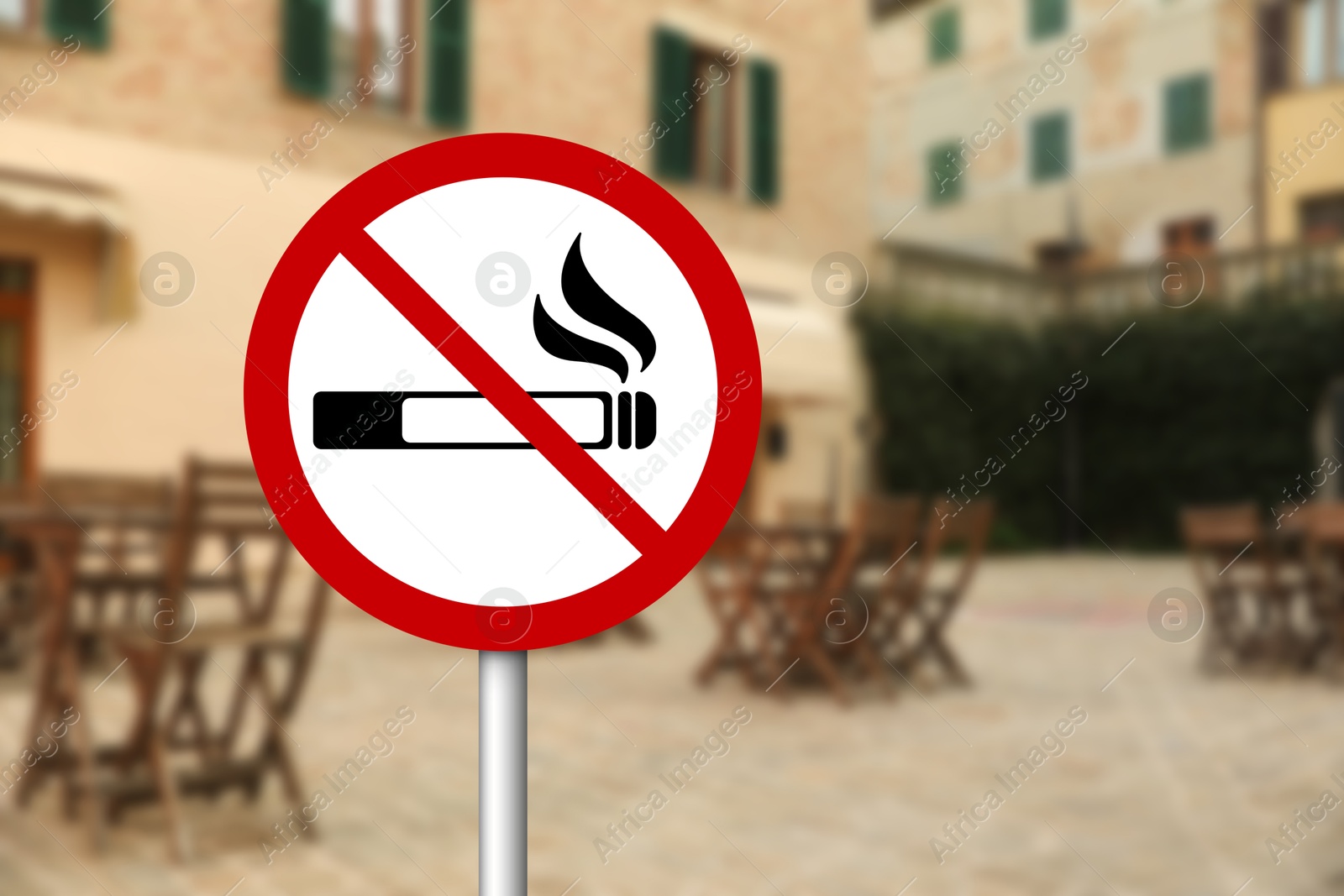 No Smoking sign near outdoor cafe on city street. Space for text Image of No Smoking sign near outdoor cafe on city street. Space for text