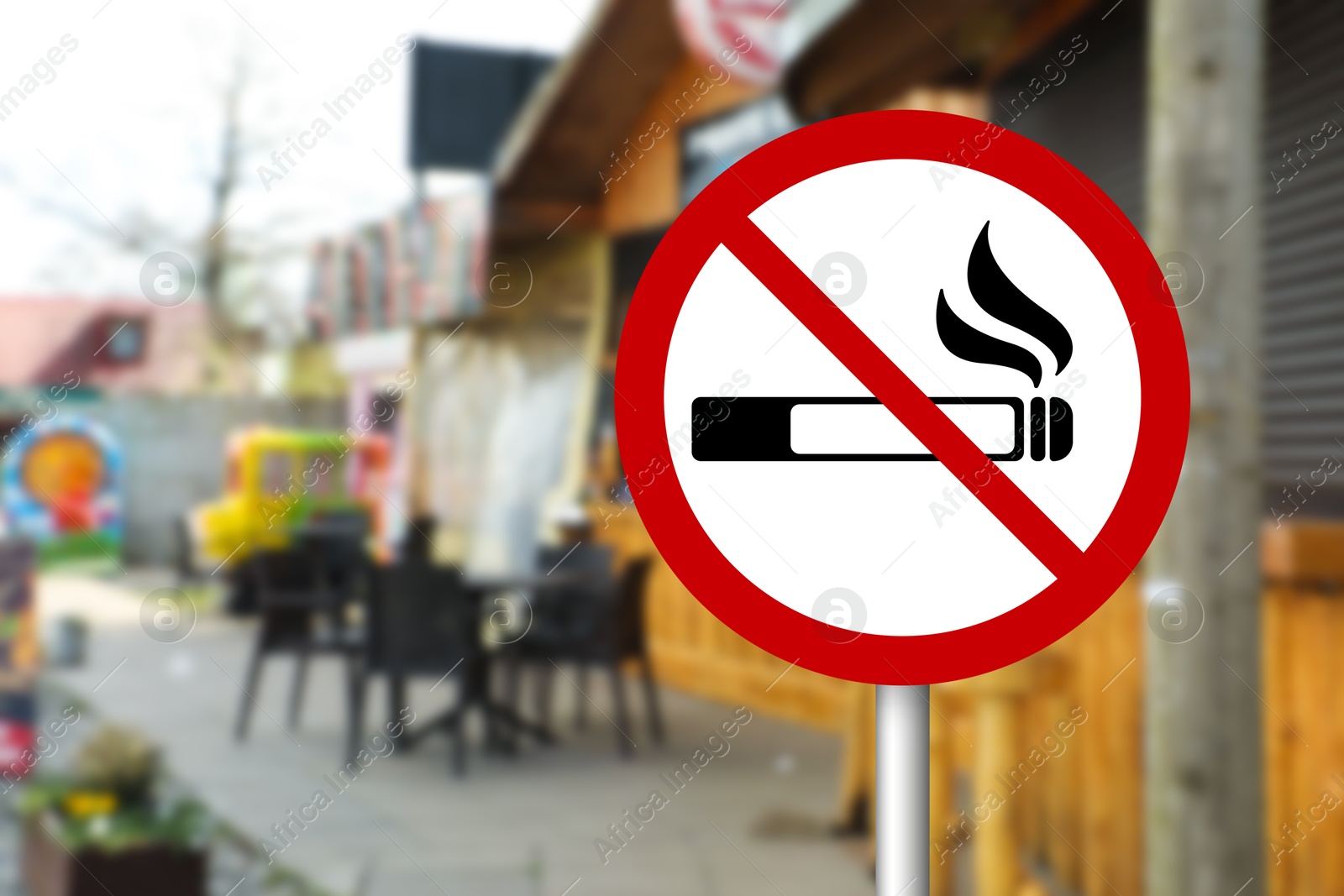 No Smoking sign on city street. Space for text Image of No Smoking sign on city street. Space for text