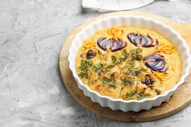 Photo of Delicious focaccia with flowers made of vegetables on grey textured table. Space for text