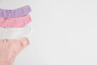 Photo of Women's underwear. Beautiful panties on white background, flat lay. Space for text