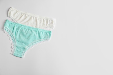 Photo of Women's underwear. Beautiful panties on white background, flat lay. Space for text
